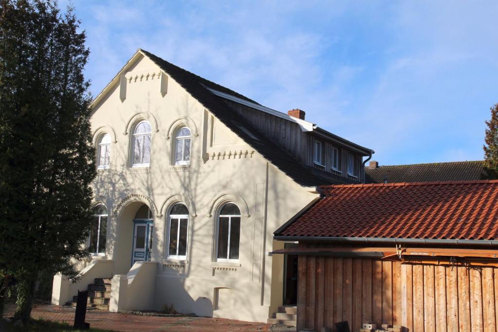 a white church with a black roof at Oberdeck Steuerbord in Greetsiel