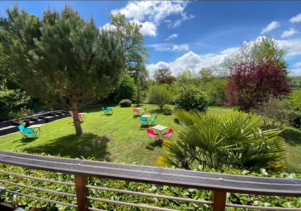 a view of a garden with chairs and tables at Chez Jade et Zoé in Ortholès