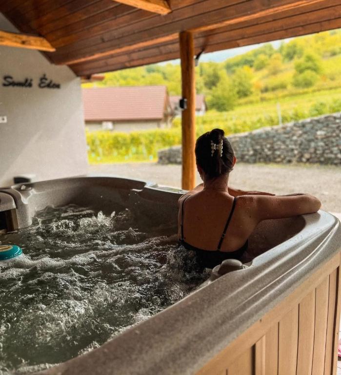 a woman sitting in a hot tub at Somló Éden in Somlószőlős