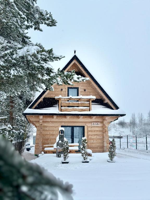 a small building with snow on the ground at Chochołowski Zakątek in Chochołów