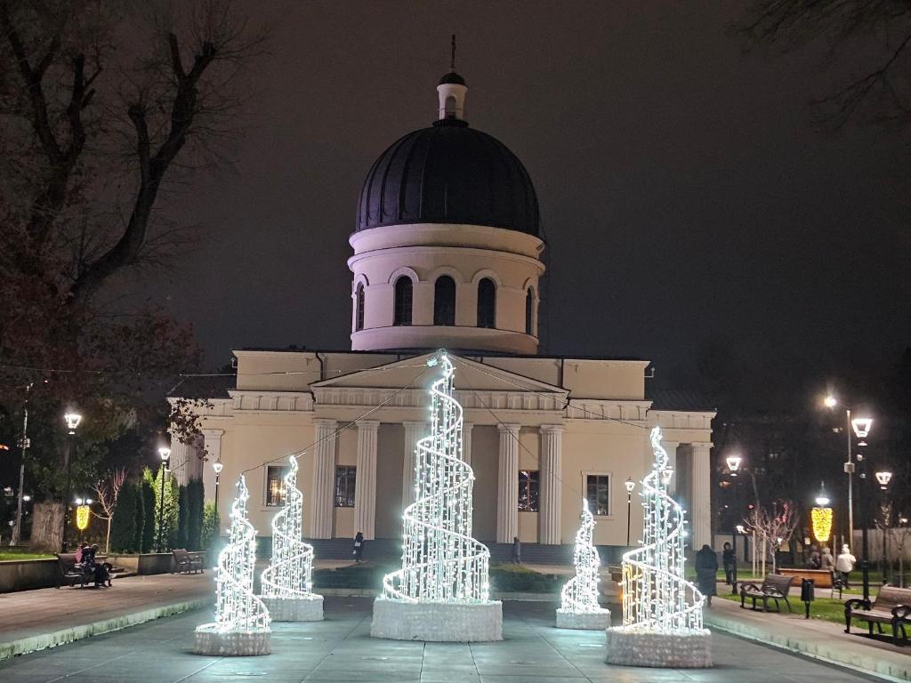 a building with christmas lights in front of it at Central Location Apartment in Chişinău