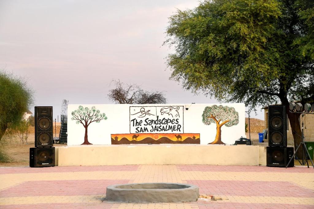 a sign for a sun museum with trees on it at Sandscapes Sam Jaisalmer by ADB Hospitality in Jaisalmer