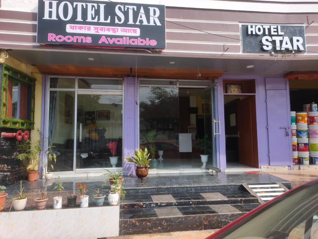 a hotel store with plants in the front of it at Hotel Star, Agartala in Agartala