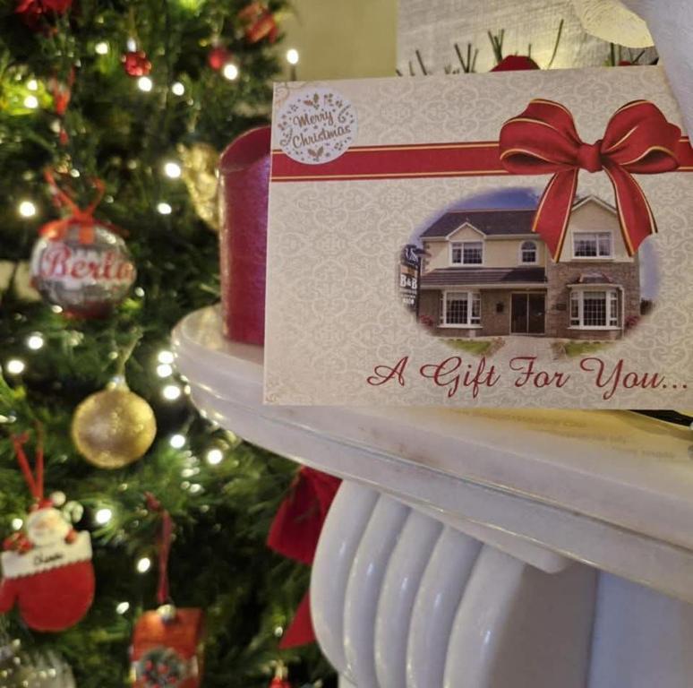 a gift for you card on a shelf next to a christmas tree at Jordan's Drum Haven B&B, Knock in Knock