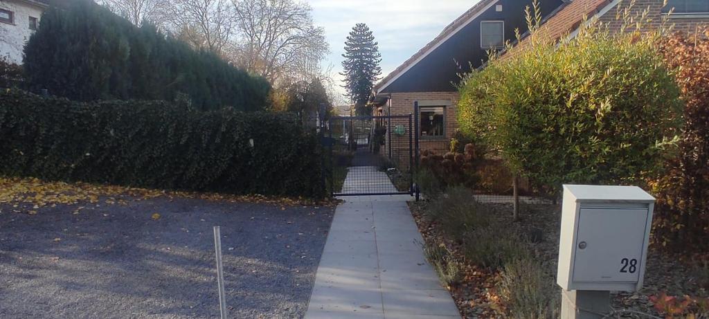 a house with a mailbox on the side of a sidewalk at Le Flanelmont in Theux