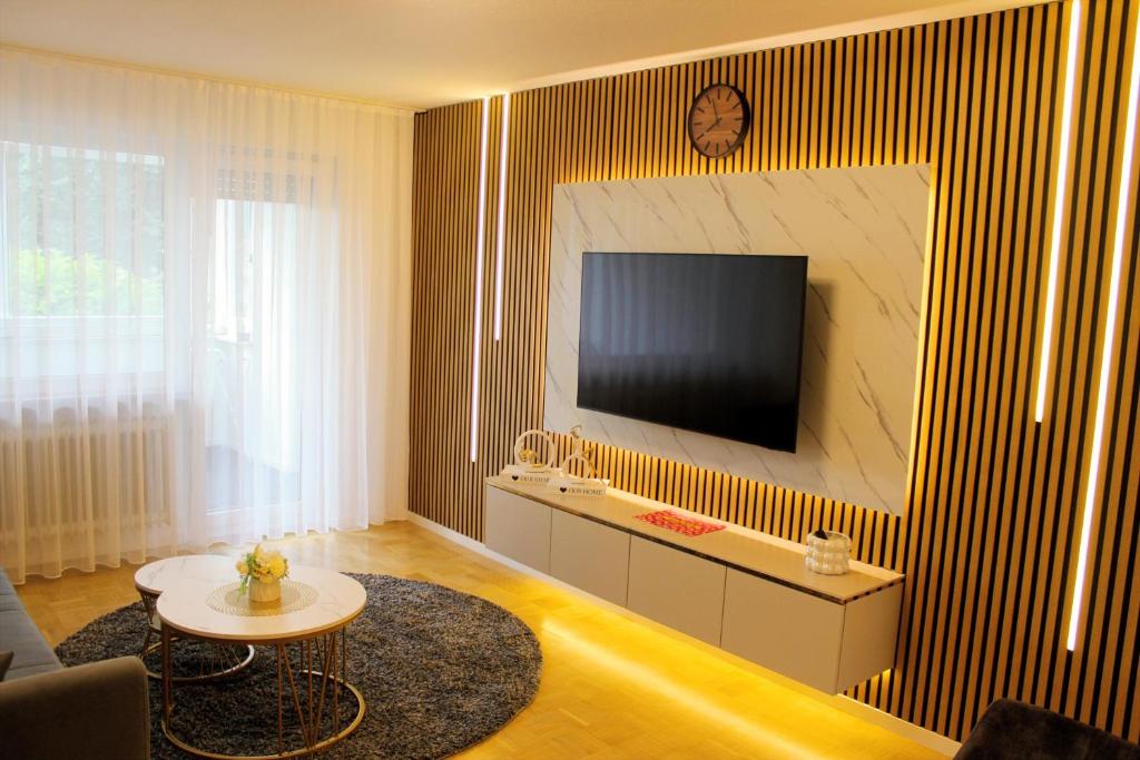 a living room with a flat screen tv on a wall at Lian am See in Friedrichshafen