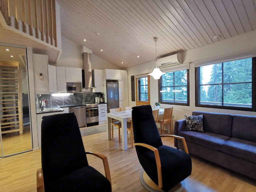 a living room with a couch and a table at Villa Aurora in Syöte