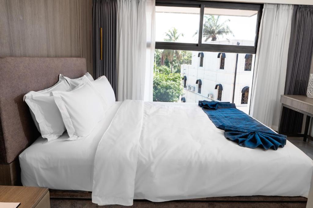 Ένα ή περισσότερα κρεβάτια σε δωμάτιο στο Lux Inn Hotel