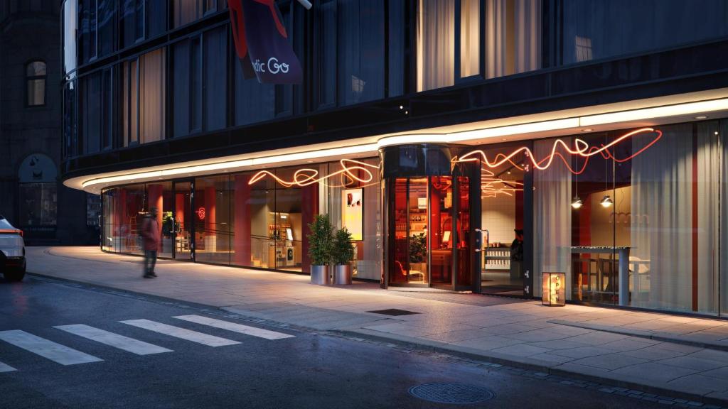 a store on a city street at night at Scandic Go, Grensen 20 in Oslo