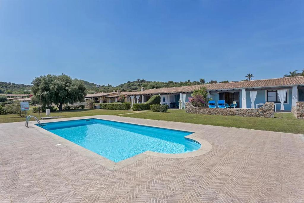 a swimming pool in front of a house at La Casa Azzurra in Tertenìa