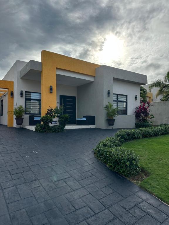 a large white and yellow house with a courtyard at Serenity Villas in Ocho Rios