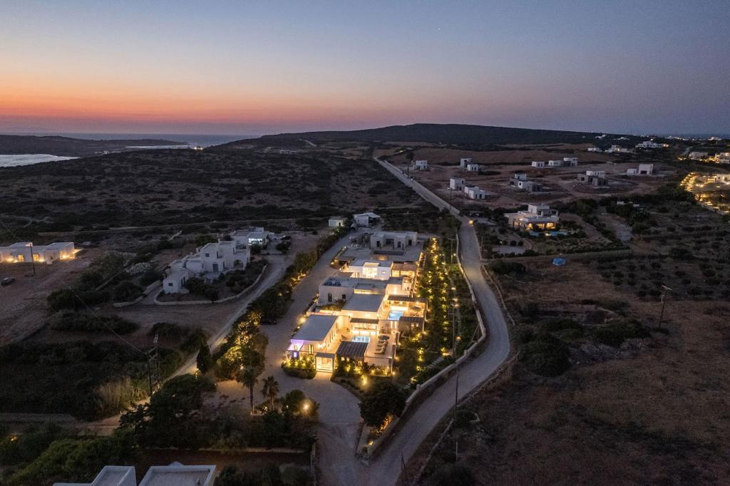 an aerial view of a city at night at Noble Pearl Villas Paros in Santa Maria