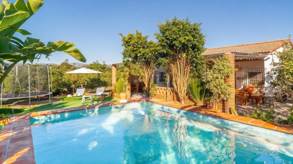 a swimming pool in the backyard of a house at Villa Rocío, Acogedora villa con piscina de agua salada en Vélez Málaga in Almayate Alto