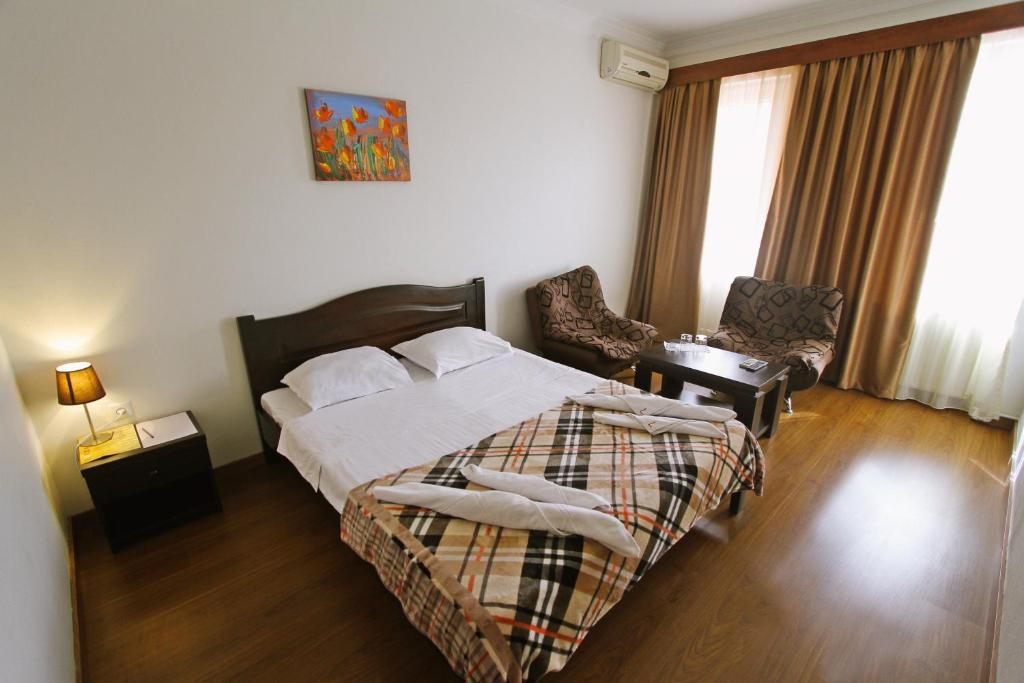 Postel nebo postele na pokoji v ubytování Hotel Lux