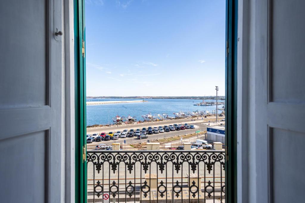 a view of a beach from a window at Palazzo Celina in Gallipoli