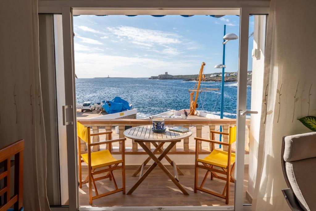 a balcony with a table and chairs on a boat at Casa Abril by Escape Home in S'Algar