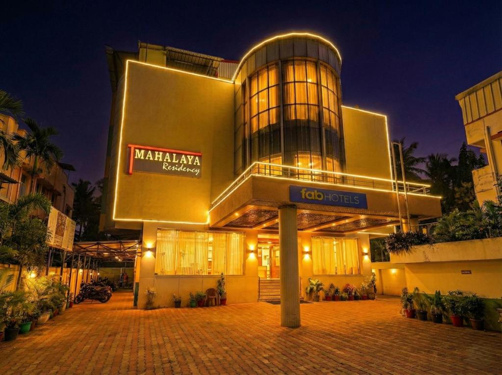 a large building with a sign in front of it at Fabhotel Prime Mahalaya Residency - Nr Pallavaram Railway Station in Chennai
