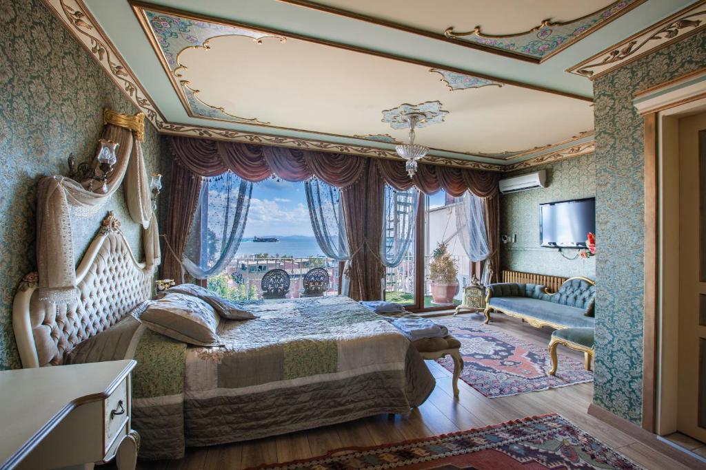 a bedroom with a bed and a large window at Romantic Hotel Istanbul in Istanbul