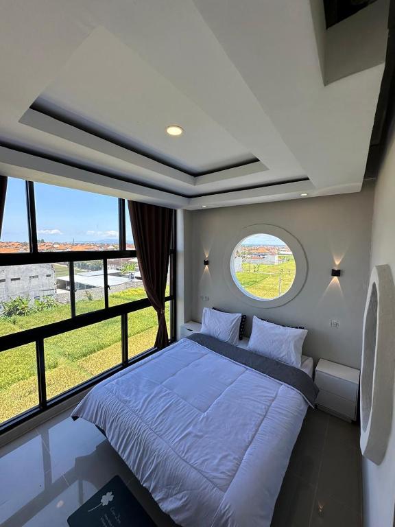 a bedroom with a large bed and a window at On The Moon in Ketewel
