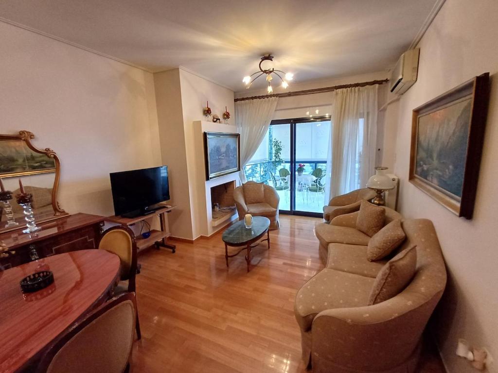 a living room with a couch and a table at Mary's vintage house in Athens