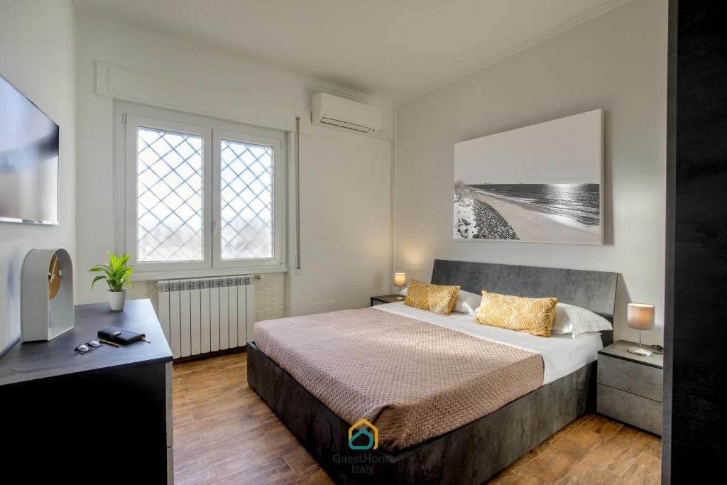 a bedroom with a large bed and a television at Dani's House in Isola Sacra