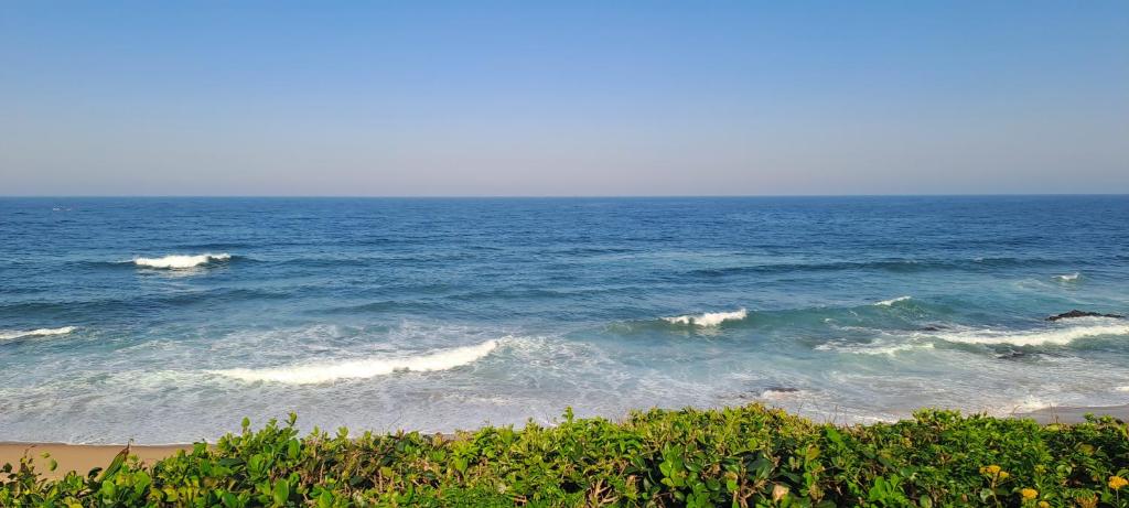 a view of the ocean with some waves at Seaside Serenity - Your ultimate beachfront escape in Sheffield Beach