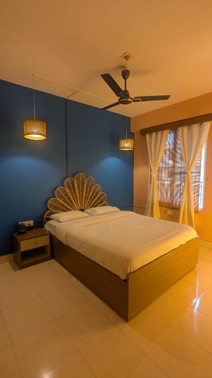 a bedroom with a bed and a ceiling fan at Seneh Homes Cultural Stay 2BHK Dispur in Guwahati