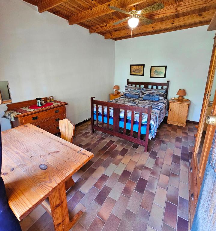 a bedroom with a bed and a wooden table at Home with The Hoffs in Smithfield