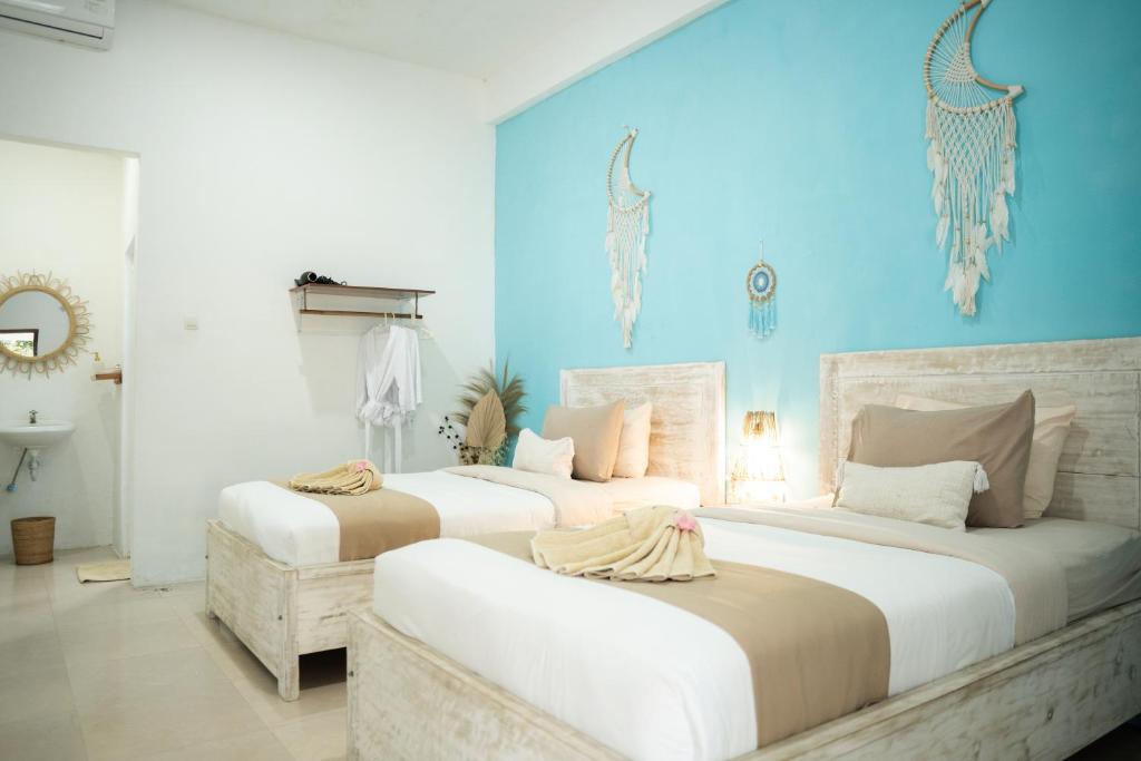 Postel nebo postele na pokoji v ubytování The White Bay Lombok