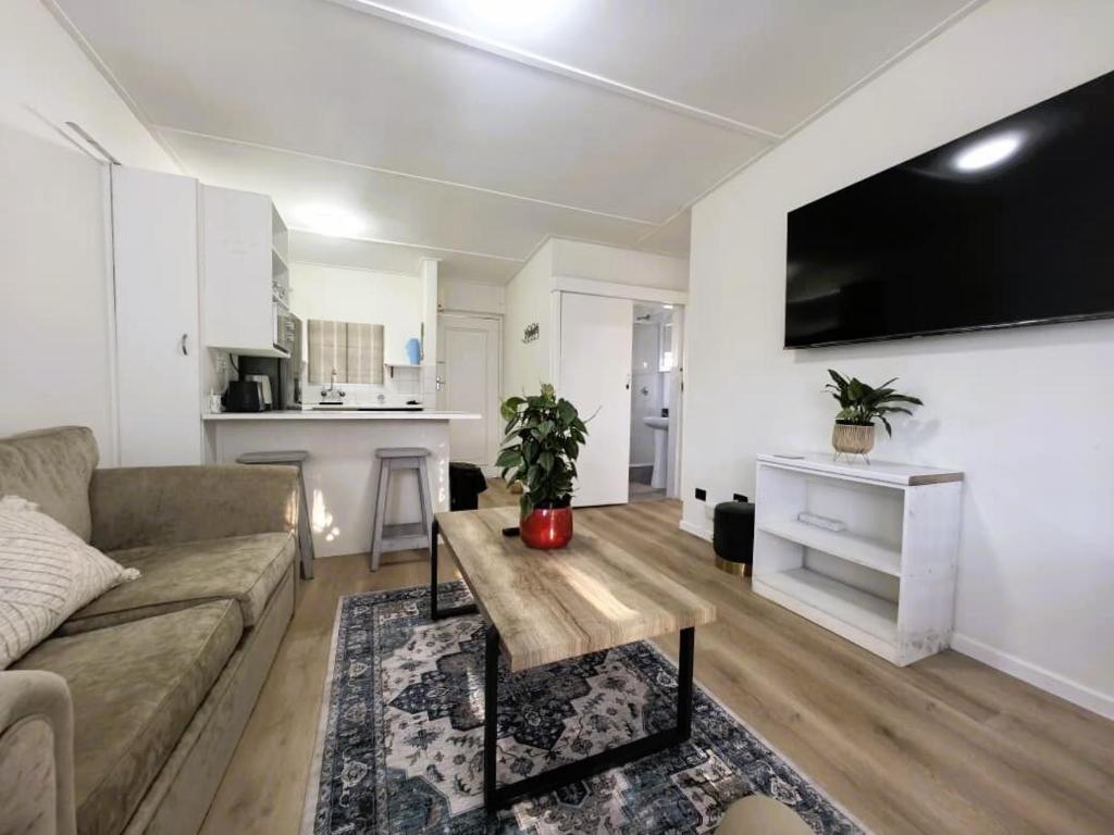a living room with a couch and a table at Offbeat off Dorp in Stellenbosch