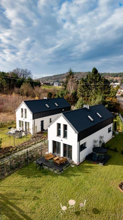 an aerial view of a white house with a black roof at La Jura in Podlesice
