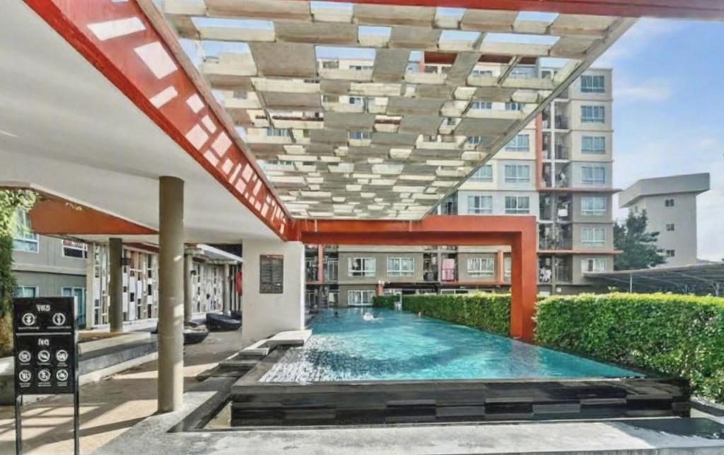a swimming pool in the middle of a building at Dcondo Kathu - Top Floor 1 Bdr Condo with shared Pool in Kathu