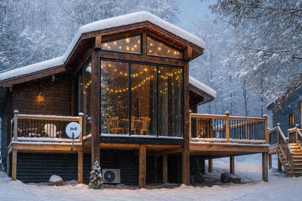 a log cabin with a deck in the snow at Muskoka Lakeview Cottage - Pier 100 #40 in Port Carling