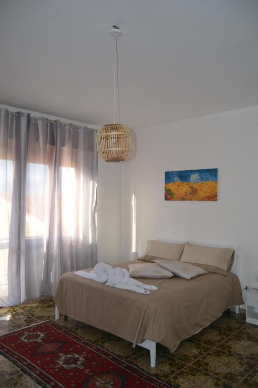 a bedroom with a bed and a chandelier at The Domus in Olmedo
