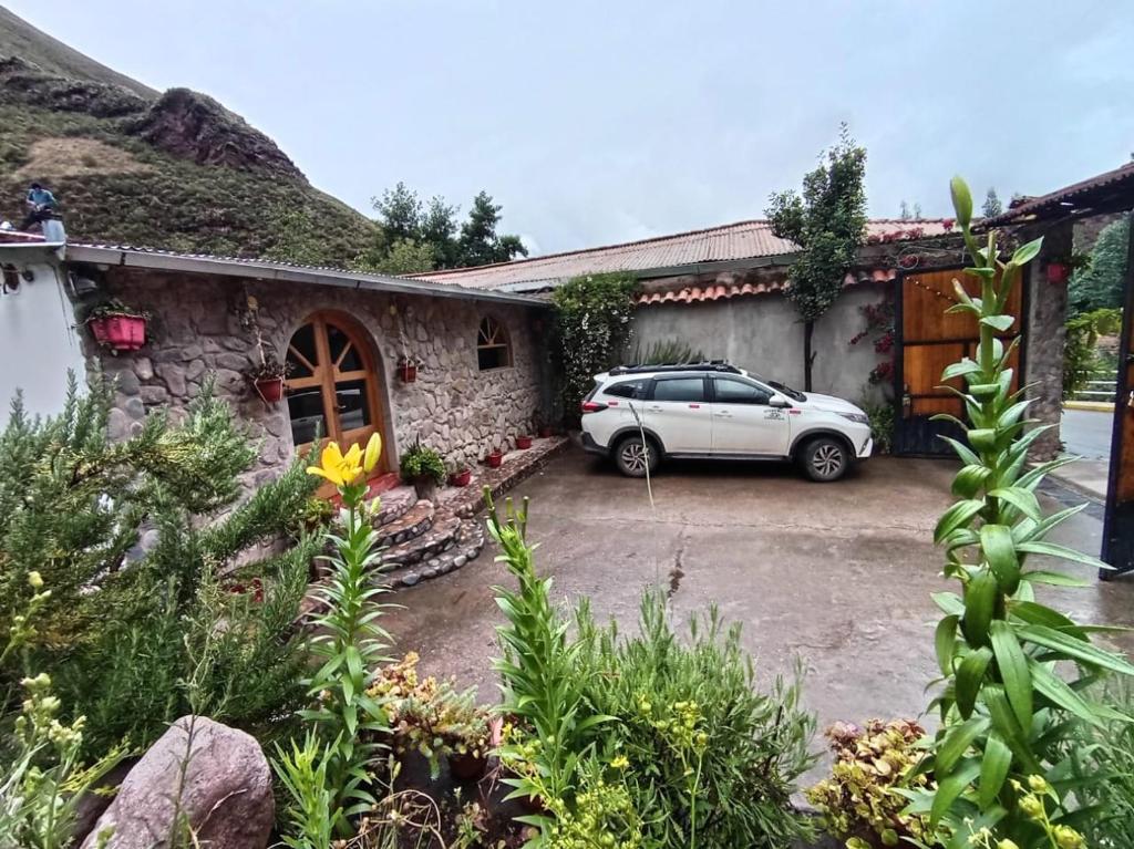 a car parked in a parking lot next to a building at Huilka Mayu in Urubamba