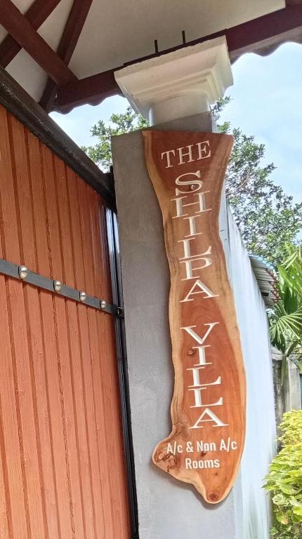 a sign on the side of a building at The Shilpa Villa in Unawatuna