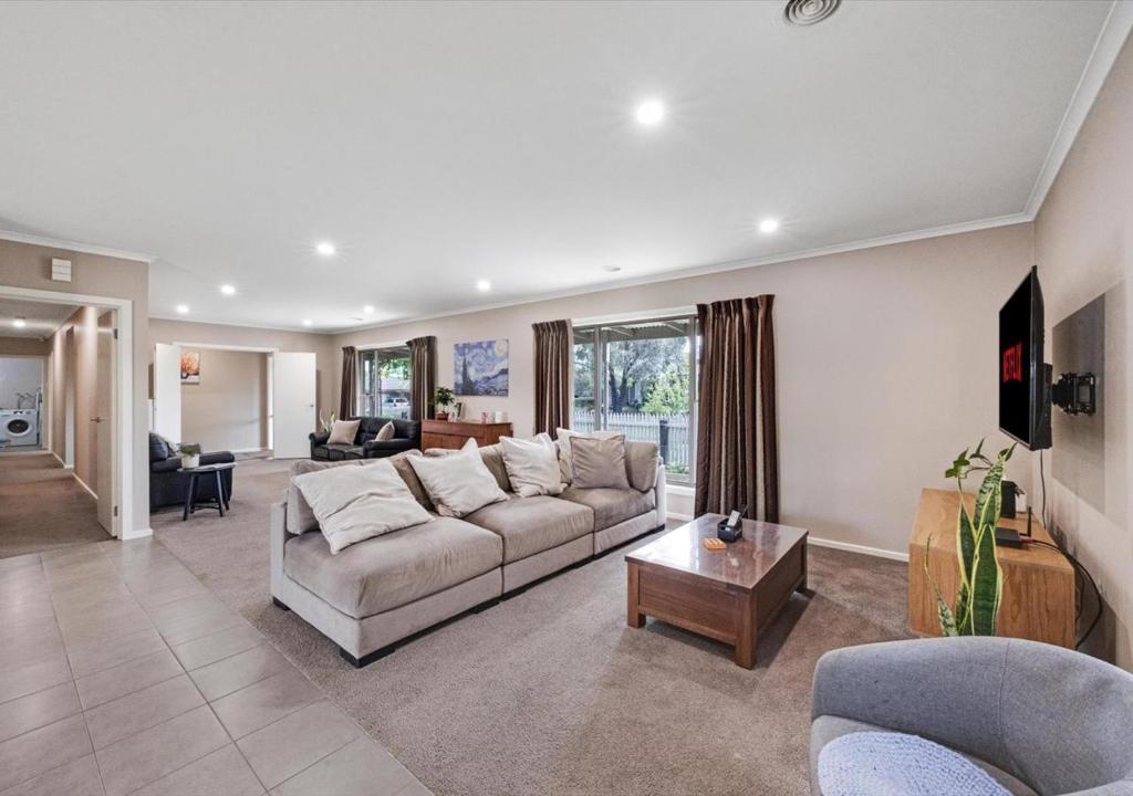 a living room with a couch and a table at LUXURY 3-Bed Home Perfect for Families & Groups in Sebastopol