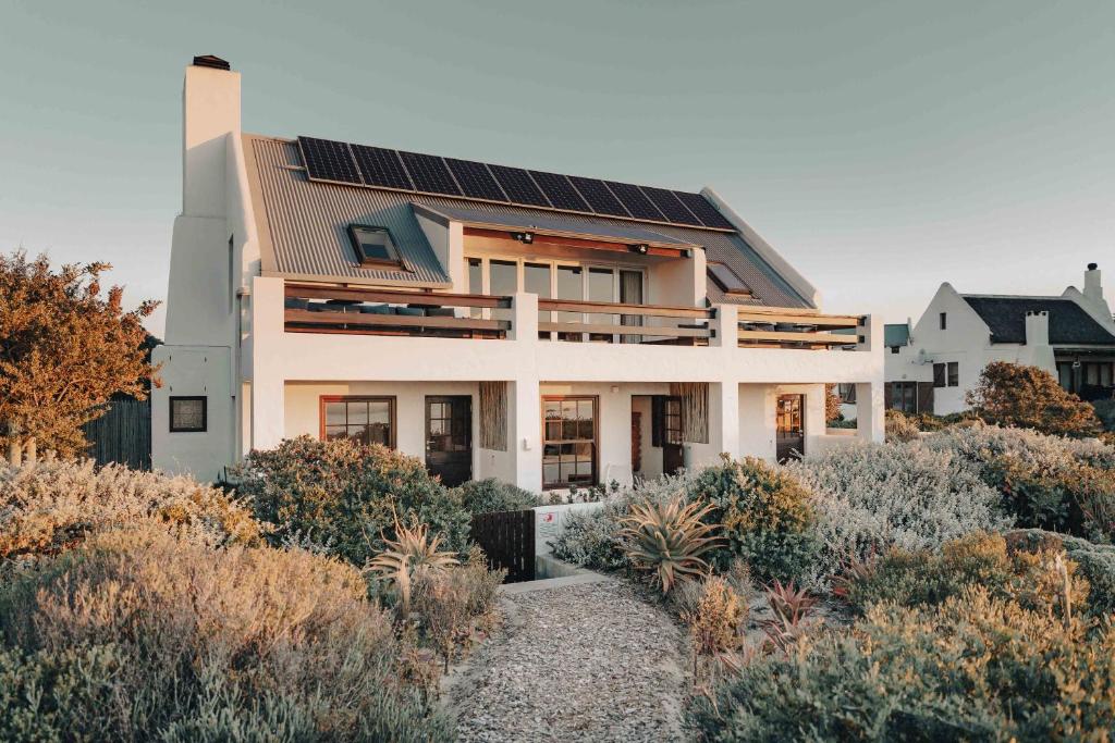 a house with solar panels on its roof at Gonana Guesthouse in Paternoster