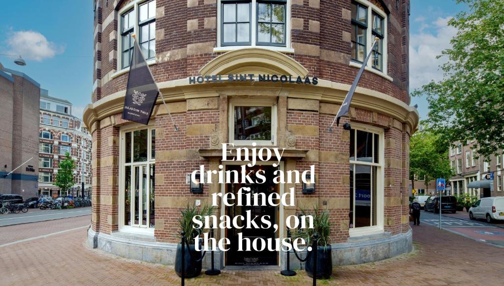 a building with a sign on the side of it at Hotel Sint Nicolaas in Amsterdam