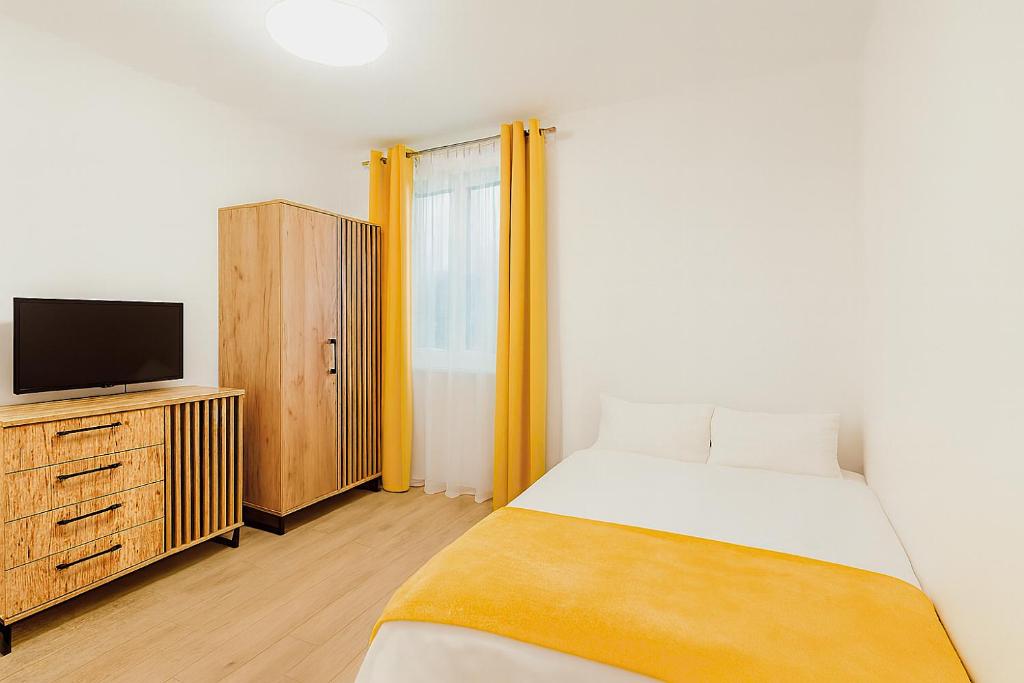 a bedroom with a bed and a tv on a dresser at Leśny Zakątek I Małe Bieszczady w Rzeszowie I grill sauna Starowiejska 6 Rzeszów in Rzeszów