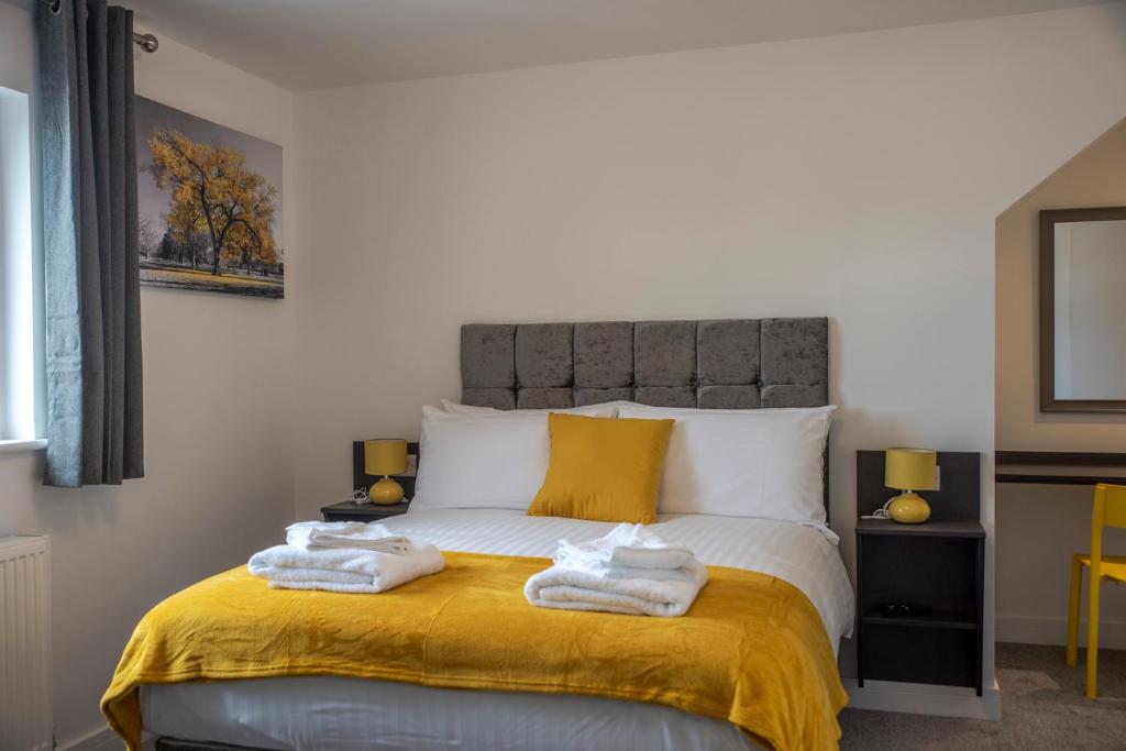 a bedroom with two towels on a bed at City & Station Stays at Gulland House by Pureserviced in Plymouth