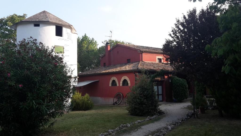 a red and white building with a white tower at Agriturismo Case Mori in Rimini