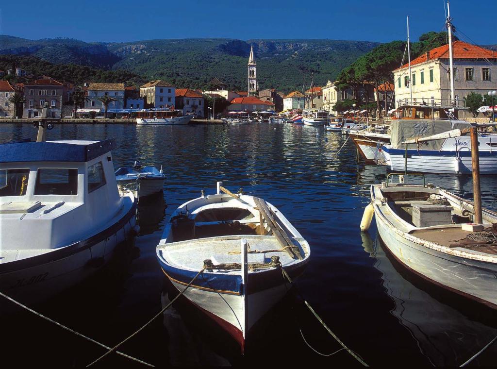 a group of boats are docked in a harbor at Apartments Rubinić in Jelsa