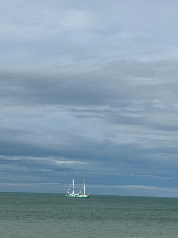 a boat in the ocean on the water at Gîte Les pieds dans l eau à Fécamp avec pleine vue mer in Fécamp