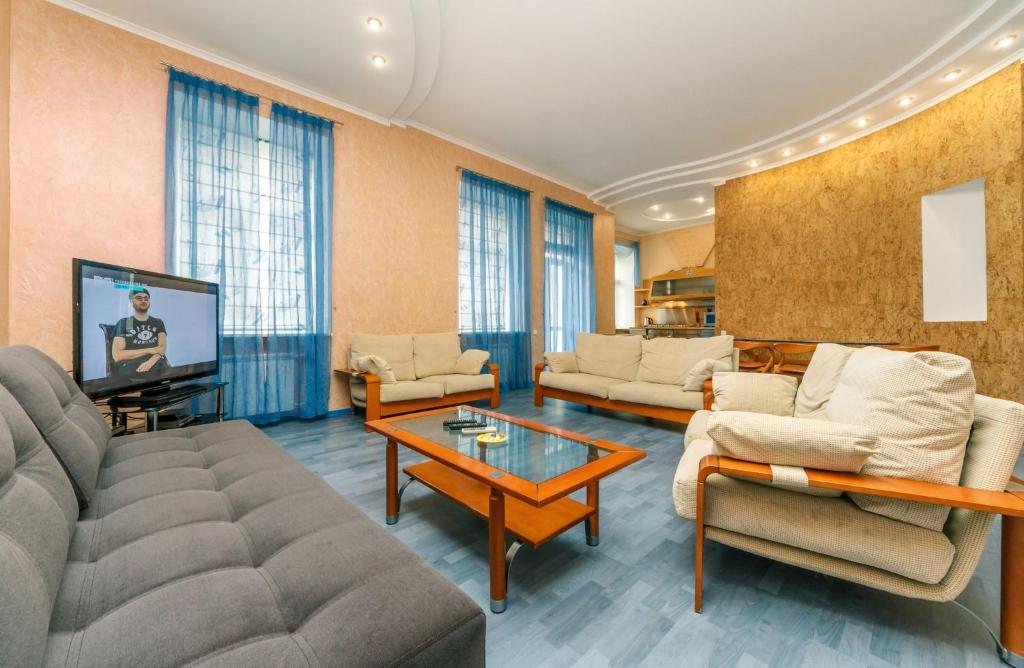 a living room with a couch and a tv at Three bedroom, 8 Lyuteranska str, Centre of Kiev in Kyiv