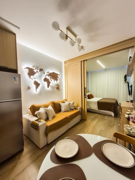 a living room with a couch and a map on the wall at Ipanema Charm and Luxury in Rio de Janeiro