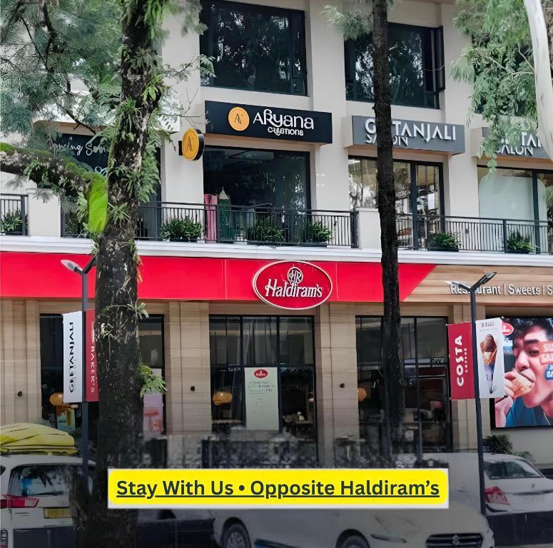 a building with a red and white sign on it at The Cozy Cool Cabin in Dehradun