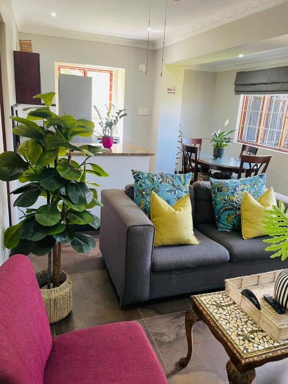 a living room with a couch and a table at 5 OYSTER COTTAGE in Durban