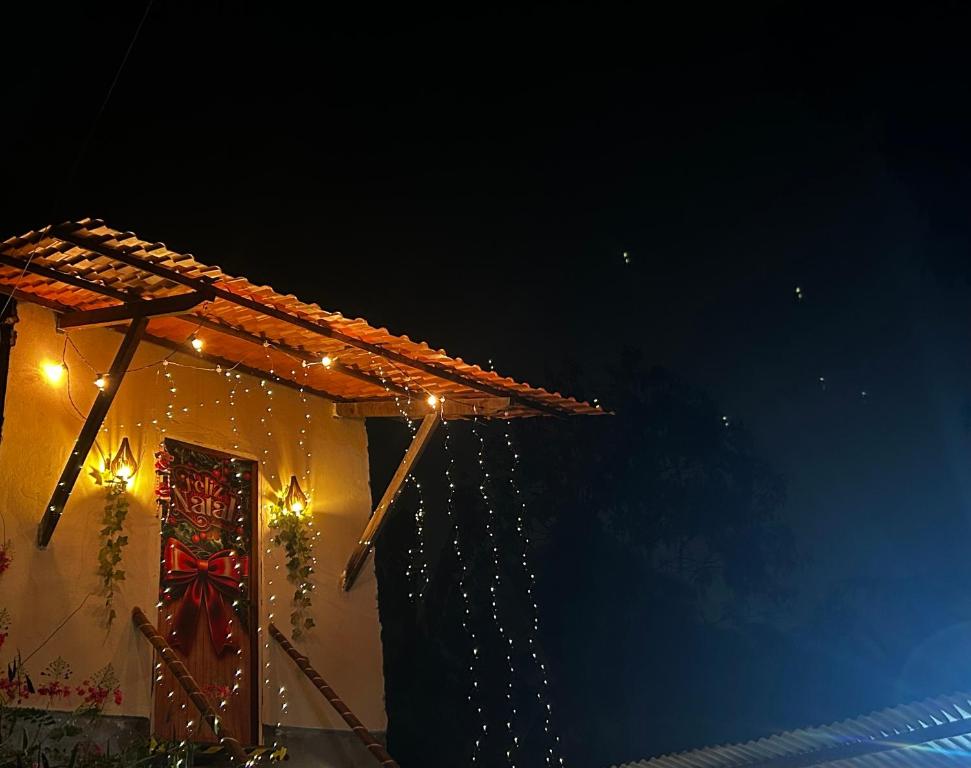 a house with christmas lights on the side of it at Apartamento Reserva Sapiranga in Praia do Forte