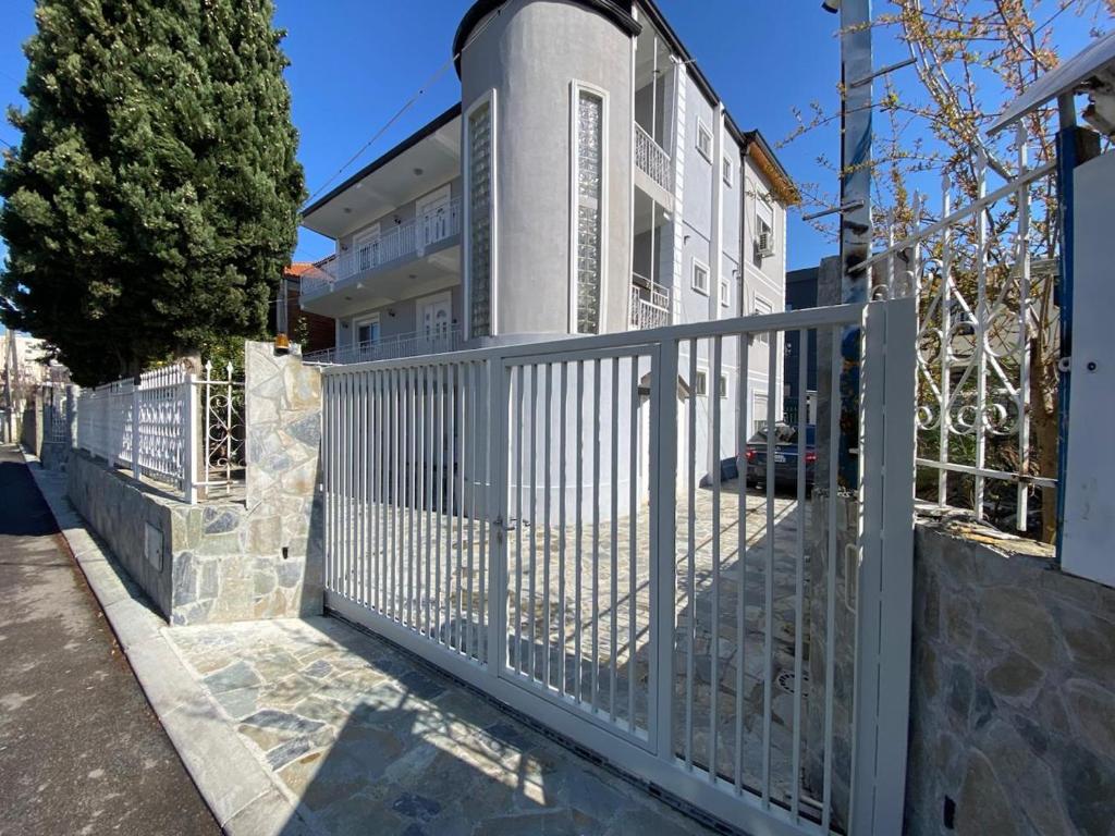 a white fence in front of a house at Villa CTT in Tirana